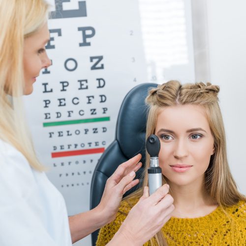 oculist examining beautiful patient in clinic